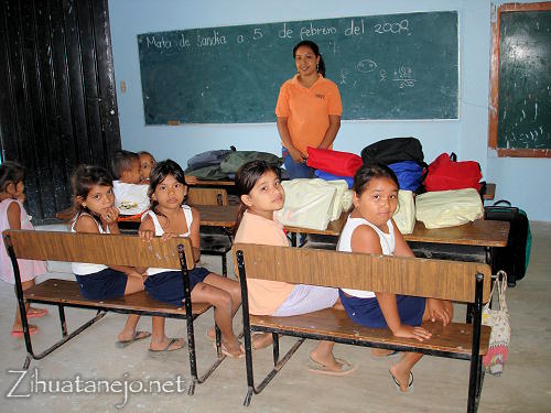 La maestra y los estudiantes con donativos en la escuela de Mata de Sand�a